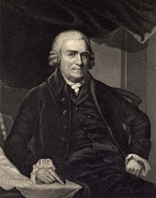 A black-and-white engraved portrait of an 18th-century gentleman with a powdered wig, seated in formal attire with a quill in hand and a book before him. The image humorously pairs this colonial-era figure—evoking the Founding Fathers' spirit of rebellion against centralized monetary control—with the caption "The original Bitcoiner," framing him as a proto-cryptocurrency advocate for his support of sound money principles.