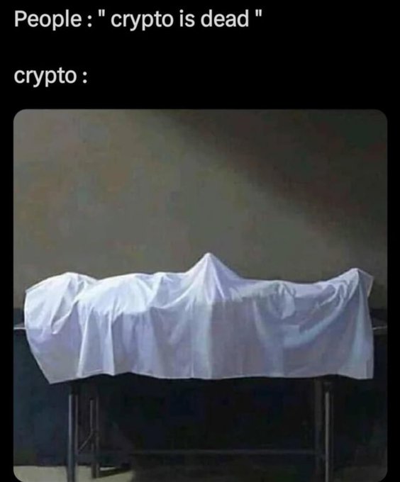 A meme with the text 'People : " crypto is dead " crypto :' above an image of a white sheet draped over a body on a table, humorously depicting crypto as a corpse.