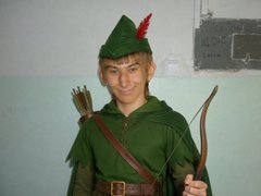 The image portrays a young man dressed as Robin Hood, a fictional character who had no connection with the cryptocurrency named Sminem Coin. The post warning about fake Sminem Coins appears to be unrelated to the image, unless the young man in Robin Hood attire is being used as a mascot or symbol for the cryptocurrency, which is a common marketing strategy. However, there is no visible link between the costuming and the warning about fake Sminem Coins which often leverages the Robin Hood imagery to attract investors due to its association with the rebellious and elite-defying nature of Hood's character. It's crucial to verify such claims before making investments. This warning serves as a cautionary tale to avoid potential scams in crypto markets.