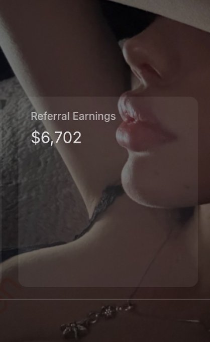A suggestive photo of a person's lower face and neck with a translucent overlay displaying 'Referral Earnings $6,702' in white text.