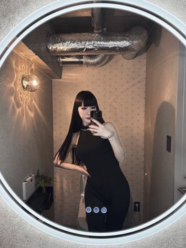 A woman poses in a mirror selfie wearing a sleek black outfit, her reflection captured against a stylish backdrop—fittingly paired with the post announcing her friend's new dental clinic in Akasaka, Tokyo, now accepting $JPYC and $USDC stablecoins.