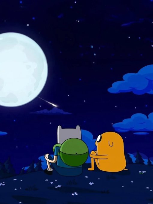 The image features two cartoon characters sitting together under a full moon at night. One character has an orange backpack, while the other has a green one. They are both looking up towards the sky, which is filled with stars. The scene appears to be set in a field or park, and there are flowers scattered around them as well.