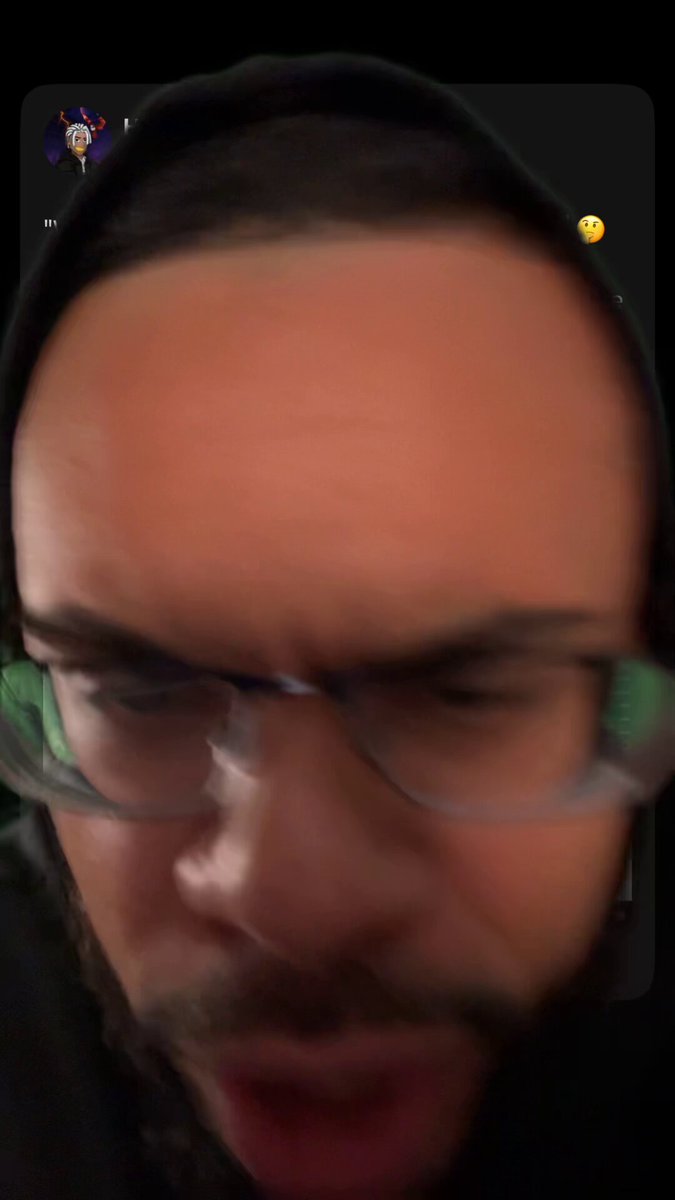 The image features a man wearing glasses with an angry expression on his face as he looks at the camera. The caption of the photo includes some text that reads "$RICH token Ambassador and content creator Nick O'Neil gives us the most brain dead take on $BTC".