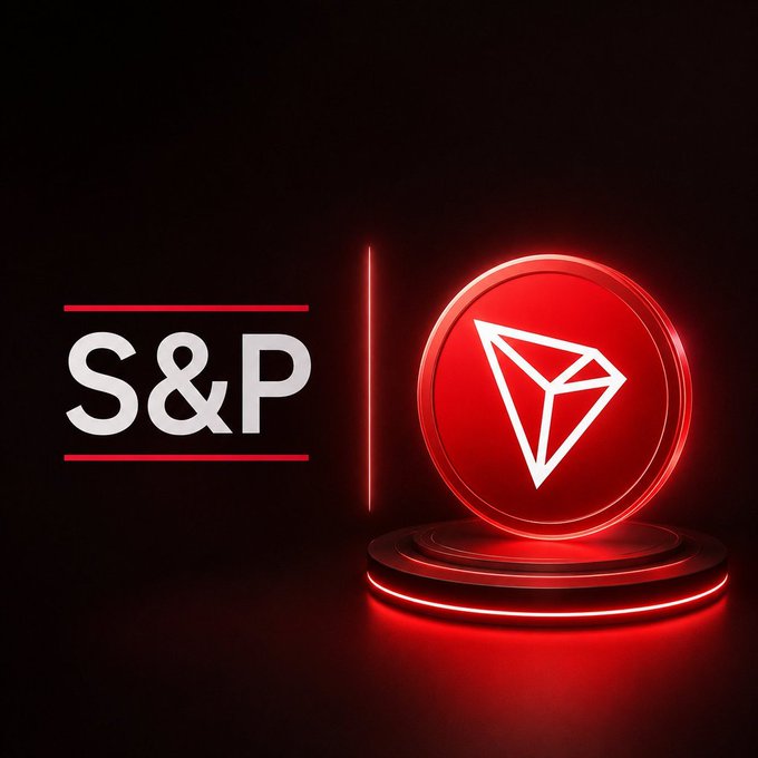 The image features "S&P" in white text beside a glowing red circular emblem displaying the TRON (TRX) logo on a podium, visually representing S&P Dow Jones Indices' launch of its first crypto index featuring TRX. The dramatic red lighting and pairing of the S&P brand with TRON's emblem reinforces the post's message about TRX's historic inclusion in a major institutional benchmark.
