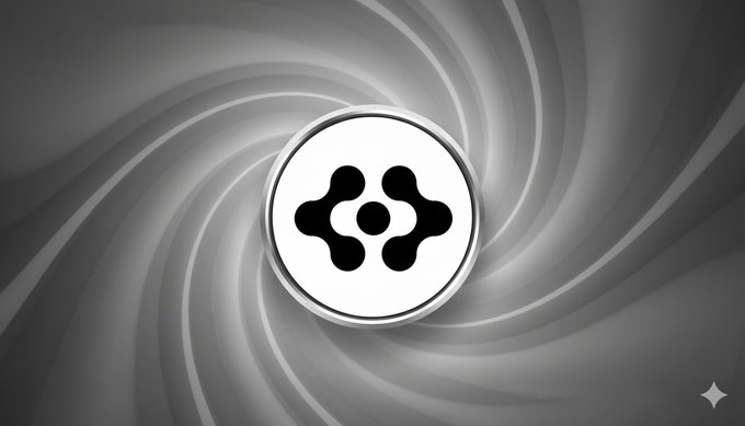 The image features a logo with a circle containing four dots, which is surrounded by a black border. The background of the image is a gradient of gray, giving it an artistic and visually appealing appearance. Below the logo, there's text that reads "Just in" followed by a number, which seems to be related to the content or context of the post. However, without more information about the specific post, it is not possible to determine the exact meaning behind this text.