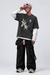 A young man in a streetwear outfit featuring a dark gray layered top with star graphics and baggy black cargo pants poses against a plain white background, wearing pink-tinted sunglasses.

The image doesn't directly relate to the post's text about Web3 struggles and watching others succeed with opportunities you desire, but visually it conveys a similar mood of aspirational ambition often associated with the Web3/crypto space through its trendy, success-oriented streetwear aesthetic.