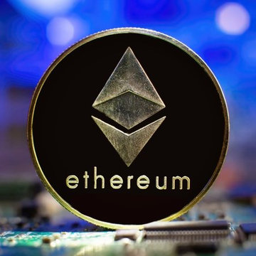 The image features a gold coin with the word "Ethereum" written on it, which is the first stablecoin issued by a US national bank. The coin's design includes an ether symbol at its center, representing the cryptocurrency that underpins the digital currency system. The coin is placed in front of a computer chip or circuit board, suggesting that it might be used for computing purposes or as part of a larger technological project.