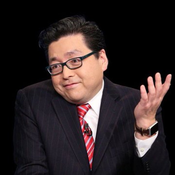 A man in a dark pinstripe suit, red striped tie, and glasses gestures with his right hand while speaking against a black background. The image likely depicts Tom Lee, the Fundstrat strategist referenced in the breaking news about BitMine acquiring an additional 20,000 ETH (~$48.89 million) from Kraken.