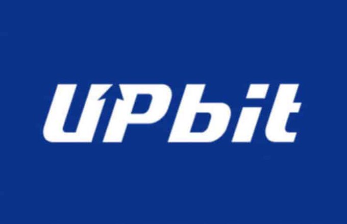 The Upbit logo is displayed in white text on a dark blue background, with an upward arrow incorporated into the letter "U".