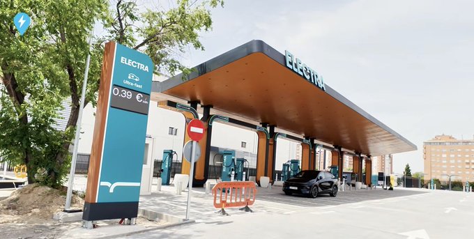 An Electra fast-charging station features a modern canopy with multiple EV chargers, where a price of 0.39 €/kWh is displayed on the signage, illustrating the company's growing electric vehicle charging network across Europe.