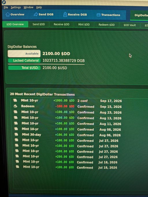 A computer screen showing a DigiDollar (DigiDollar/DGB) wallet interface with an available balance of 2100.00 $DD, locked collateral of 10,23715.383888729 DGB, and a transaction history showing mint and redeem operations.