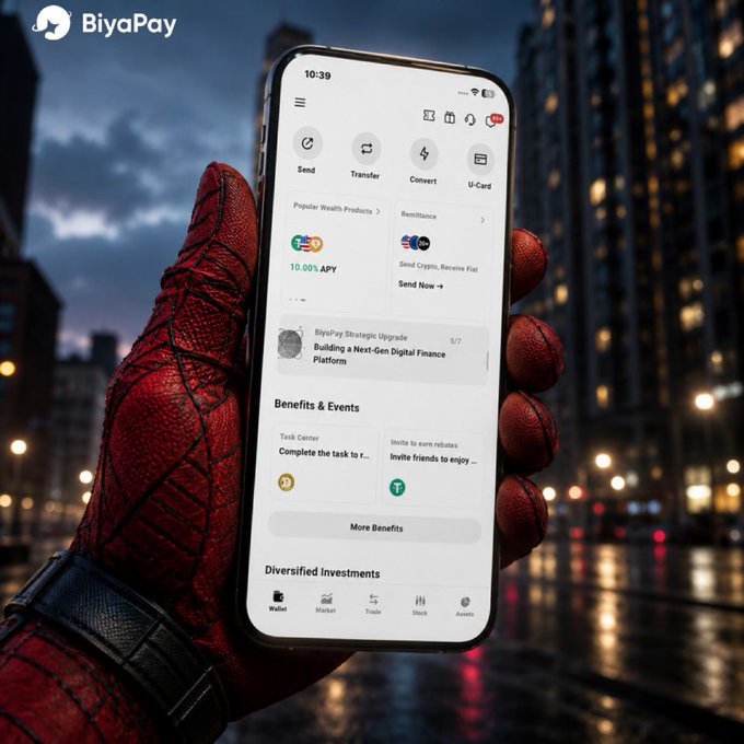 A Spider-Man gloved hand holding a smartphone displaying the BiyaPay app interface, set against a nighttime city skyline backdrop.