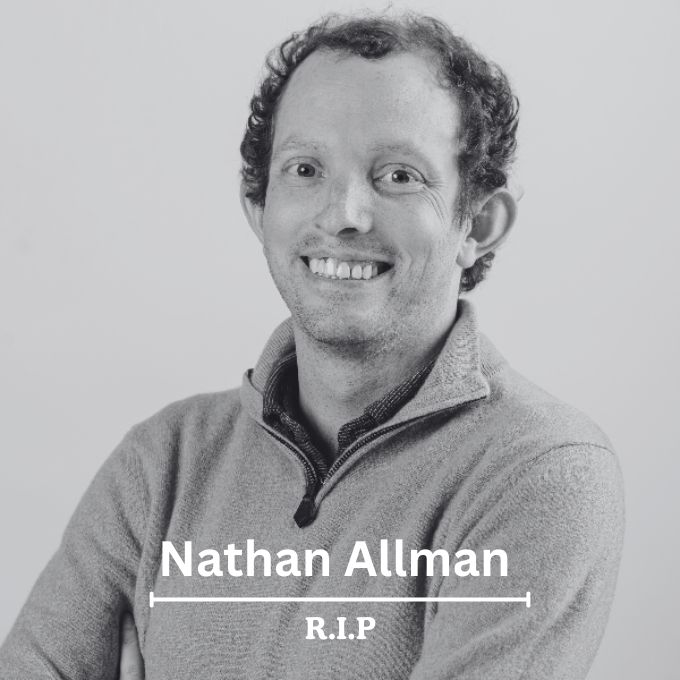 The image features a black and white photograph of a man wearing a gray sweater with the name "Nathan Allman" written above his head. The photo also includes a line that reads "RIP Nathan Allman". This suggests that the image is related to a memorial or tribute for the late Nathan Allman, who was a founder and CEO of Ondo Finance.