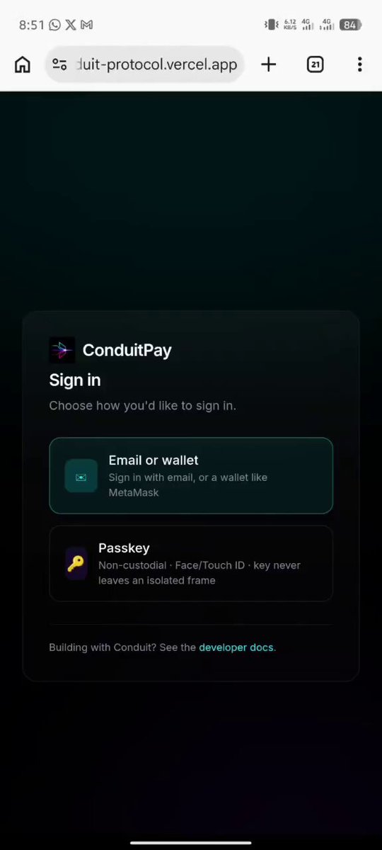 The image shows a phone screen displaying an app called ConduitPay with a sign-in page. The app has a green button that says "Sign In" and there are two other buttons, one for entering a seed phrase and another for entering an email address. The text on the screen indicates that the app is designed to be used as a payment gateway and it allows users to send payments via their email addresses.