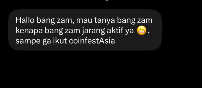 A dark-themed text message in Indonesian: 'Hallo bang zam, mau tanya bang zam kenapa bang zam jarang aktif ya 😅, sampe ga ikut coinfestAsia'.