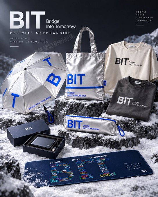 A product photo displaying BIT (Bridge Into Tomorrow) official merchandise including an umbrella, tote bag, t-shirts, wallet, and mousepad arranged on snow.