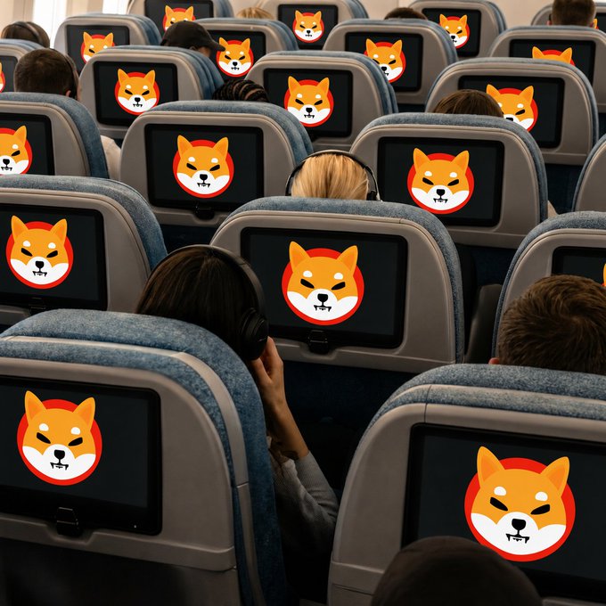 The image shows passengers seated on an airplane, each looking at seatback screens displaying the Shiba Inu ($SHIB) cryptocurrency logo, visually reinforcing the post's bullish sentiment that #SHIB is about to take off. The airplane metaphor cleverly suggests the coin is ready for liftoff, with widespread adoption and attention across all passengers.