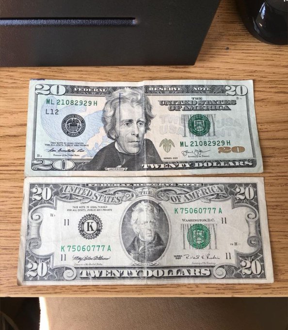 Two $20 bills (serial numbers ML 21082929H and K 75060777A) displayed on a wooden surface as prize money for a Solana giveaway.