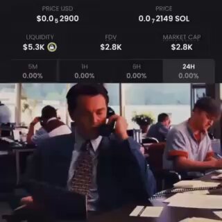 In the image, there are two men sitting at a table with chairs placed around them, both wearing suits and ties. One man is talking on the phone while the other man is studying the computer monitor. There's also another person visible outside of the frame who seems to be looking at something or listening to someone. The post suggests that these men might be traders involved in buying Bitcoin, as they are described as "traders". They could be discussing a recent transaction, market trends, or analyzing data related to the cryptocurrency exchange.