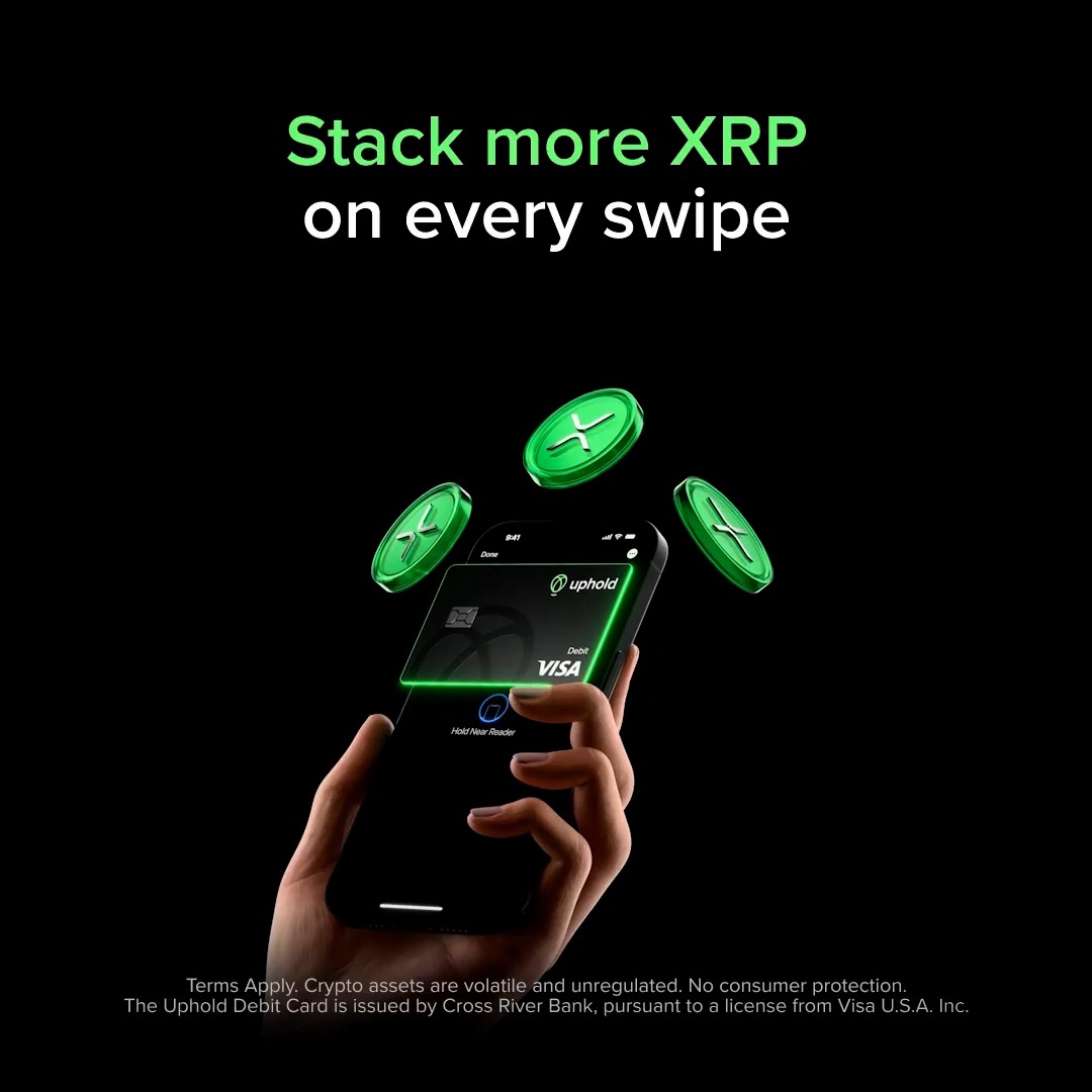 A hand holds a smartphone displaying the Uphold Debit Card via Apple Pay, with three green XRP coins floating above it against a black background. The headline reads "Stack more XRP on every swipe," promoting the Uphold Debit Card's cashback rewards in XRP cryptocurrency.