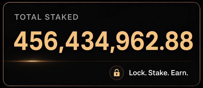 A dark-themed dashboard displaying 'TOTAL STAKED' at '456,434,962.88' with the tagline 'Lock. Stake. Earn.' and a lock icon.
