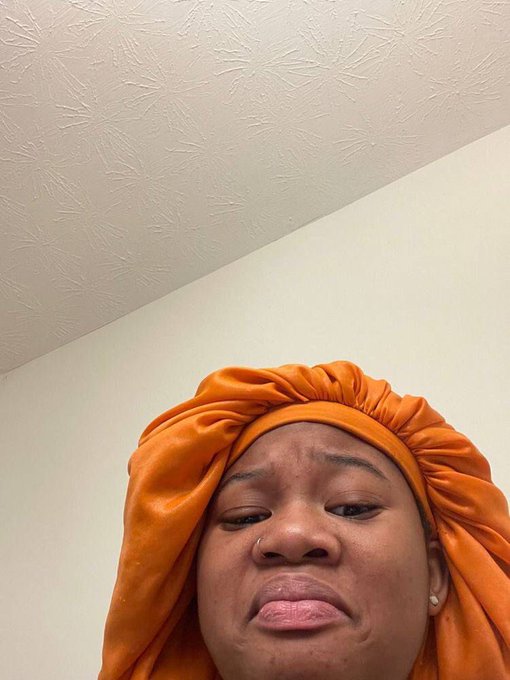 A woman wearing an orange satin hair bonnet looks up at the camera with a skeptical, unconvinced expression, as if being asked a question she doesn't fully buy into—matching the post's teasing challenge about the true motives behind joining Web3.