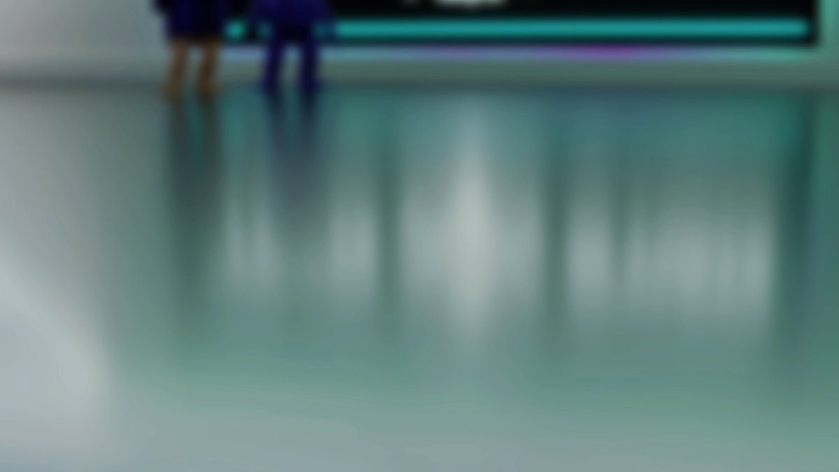 The image shows a blurry photo of two people standing next to each other, with their reflections visible in the background. The scene appears to be set in an art gallery or museum, as suggested by the presence of a painting hanging on the wall behind them. The focus of the image is on the reflection of the people and the artwork, creating a sense of depth and intrigue.