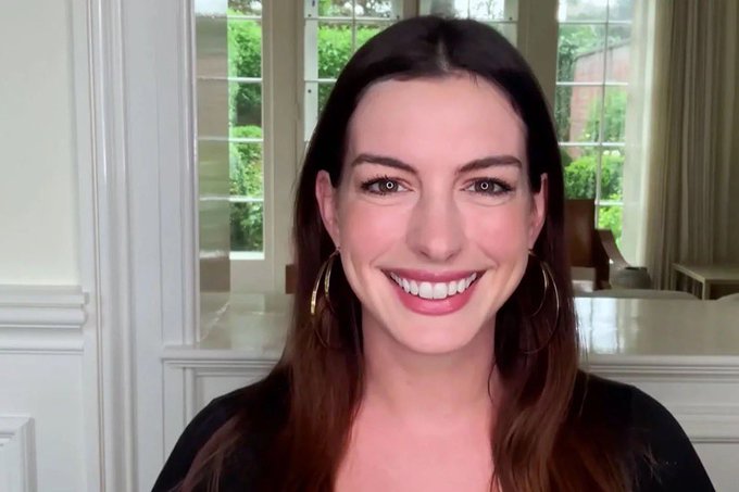 A smiling woman with long brown hair and gold hoop earrings looks directly at the camera, appearing cheerful despite the post's text delivering disappointing news about failing to achieve the required 55% signaling threshold for a BIP and being told to fork off the network.