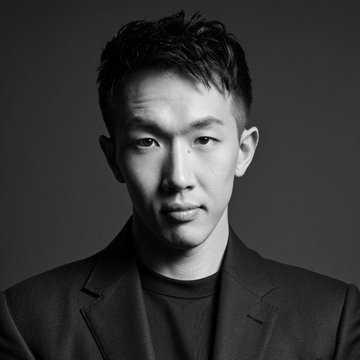 The image shows a black-and-white professional headshot of an Asian man in a dark blazer, likely representing VirtualBacon, the crypto commentator referenced in the post discussing his bullish outlook on $NIGHT and its ties to the Cardano ($ADA) ecosystem.