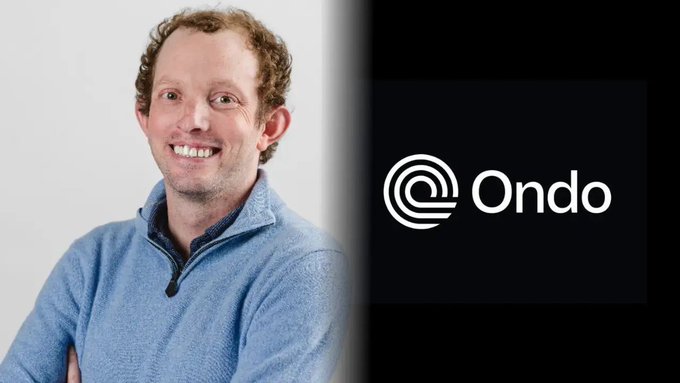 The image features a man wearing a blue sweater with a smile on his face, standing next to a black background that prominently displays the Ondo Finance logo. The text "RIP Ondo Finance" is written below the logo, indicating the loss of Nathan Allman, who was a co-founder and CEO at Ondo Finance. This image serves as a tribute to Nathan's memory and highlights the impact he had on the company's growth and success.
