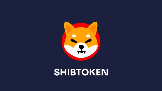 The image displays the ShibaToken logo featuring a stylized orange Shiba Inu dog face on a red circular background, with "SHIBTOKEN" written below in white text against a dark navy backdrop, visually representing the $SHIB cryptocurrency mentioned in the article about its unexplained 36% rally.
