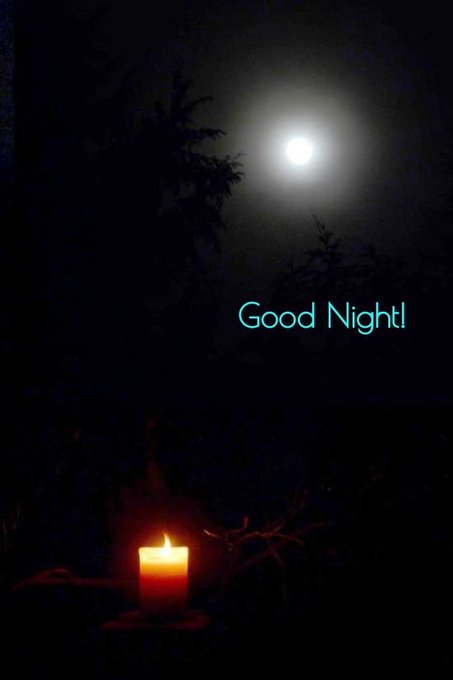 A nighttime photo of a full moon above silhouetted trees with a lit red candle in the foreground and the text 'Good Night!' in teal letters.