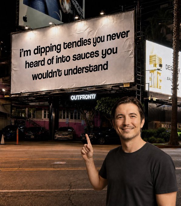 A man points up at a large billboard reading 'I'm dipping tendies you never heard of into sauces you wouldn't understand,' with an Apple ad visible nearby.