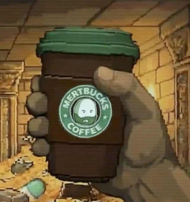 A cartoon-style image of a large hand holding a takeaway coffee cup branded with 'MERTBUCKS COFFEE,' a parody of Starbucks featuring a bearded character's face in the logo.