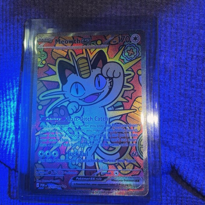 A holographic Pokémon trading card featuring Meowth ex (HP 170) with the Ability 'Last-Ditch Catch' and 'Tuck Tail' attack (60 damage), shown in a protective sleeve under blue lighting.