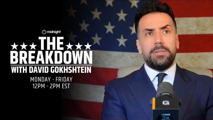 A promotional graphic for "THE BREAKDOWN WITH DAVID GOKHSHTEIN" on Midnight, airing Monday–Friday from 12PM–2PM EST, features David Gokhshtein in a blue suit speaking into a microphone against an American flag backdrop. The image supports the post's invitation to tune in for crypto market analysis, including a 1:15 PM ET segment with Charles Hoskinson discussing Cardano and Midnight.