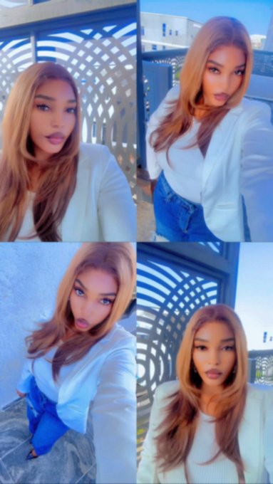 A four-panel collage shows a stylish woman with long honey-blonde hair posing in a white blazer and jeans selfies against a geometric blue-toned background, with the caption "gm frens….new week new motion" reinforcing her confident, fresh-start vibe.