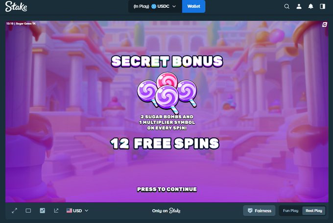 A screenshot from Stake.com's Sugar Coins slot game showing a "SECRET BONUS" screen awarding "12 FREE SPINS" with 2 sugar bombs and 1 multiplier symbol, displayed over a pink candy-themed background. The image relates to the post as it promotes a giveaway contest requiring followers to engage and comment with their USDC ERC details to win $33 prizes.