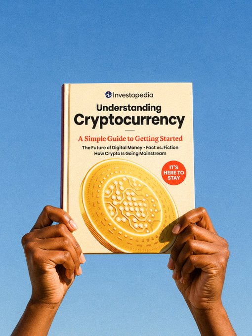 Two hands hold up an Investopedia guide titled "Understanding Cryptocurrency: A Simple Guide to Getting Started," featuring a large gold coin graphic and an "It's Here to Stay" badge against a blue sky background, visually promoting the educational resource highlighted in the post.