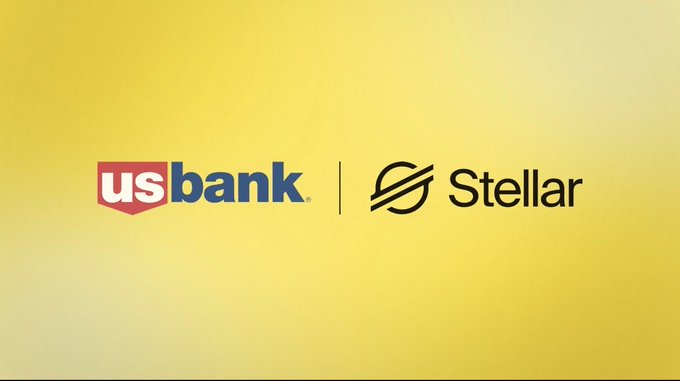 A gold gradient background displays the logos of "usbank" and "Stellar" separated by a vertical line, visually representing the partnership announced in the post regarding U.S. Bank's successful live trial of USBDC, a bank-issued USD-backed stablecoin, on the Stellar blockchain network.
