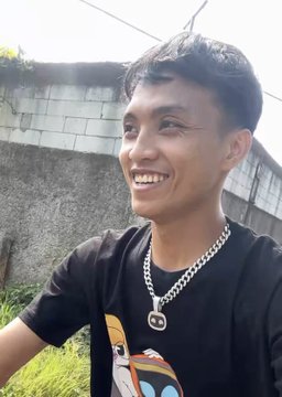 A smiling young man wearing a black shirt and a Gucci chain necklace stands outdoors, likely portraying a crypto influencer or trader. His confident grin and stylish accessories visually align with the post's narrative of a top $SI holder fearlessly navigating volatile market swings with bold conviction.