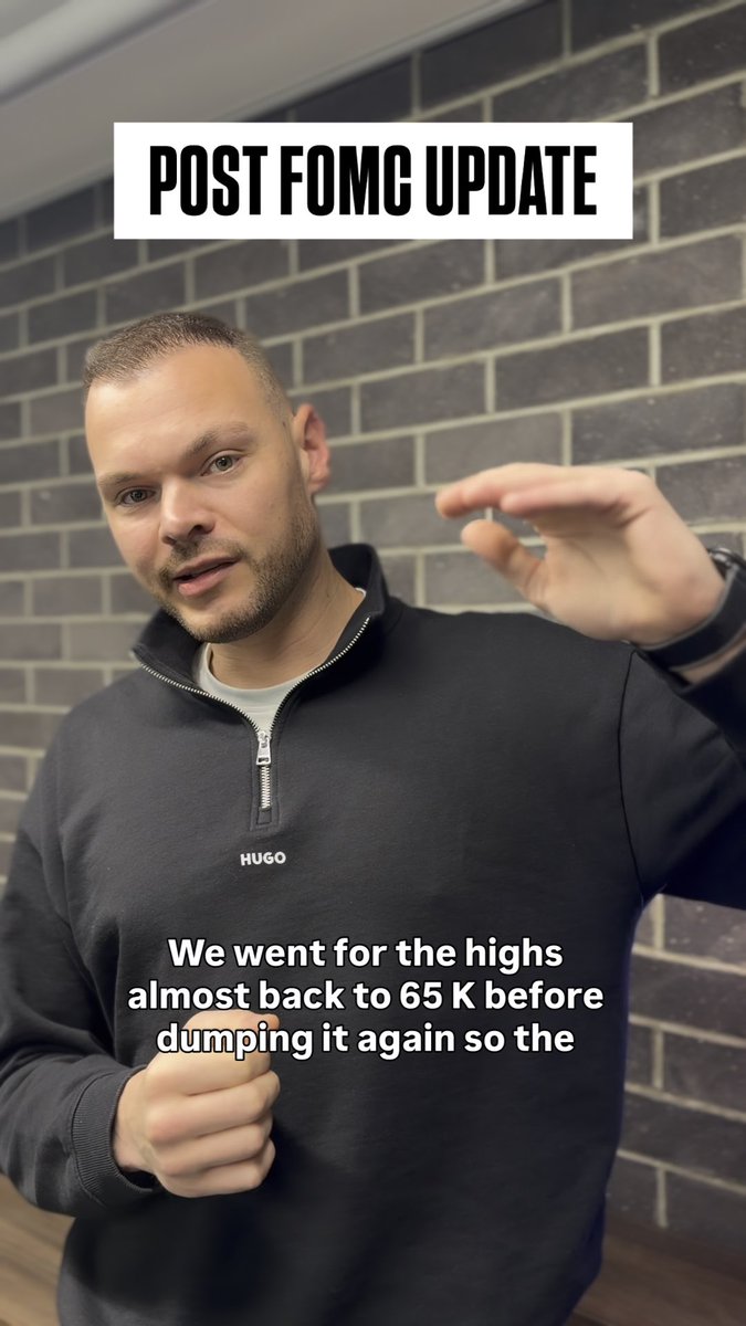 A man wearing a black Hugo sweatshirt stands in front of a brick wall, gesturing with his hands raised. The image is overlaid with text reading "POST FOMC UPDATE" at the top and "We went for the highs almost back to 65 K before dumping it again so the" at the bottom, supporting the caption's post-FOMC analysis of Bitcoin's price action around the $65K level.