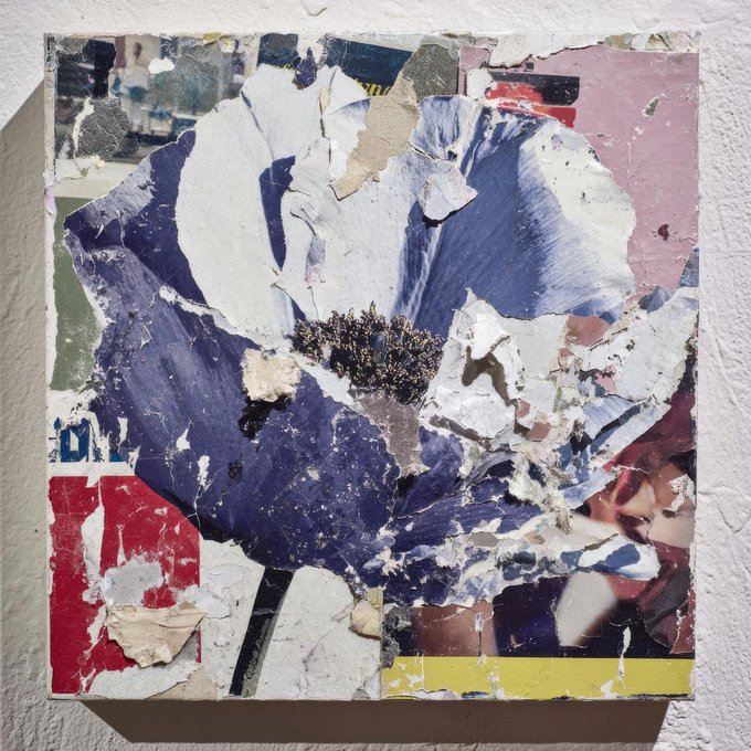A square, weathered abstract artwork featuring layered, torn paper and paint in blue, white, red, and yellow tones hangs on a textured wall, evoking a sense of creative process and imperfection. It visually complements the post's message about building something meaningful with @Frag_Growth alongside @jenyavyguzov, reflecting the raw, experimental nature of the project and the candid acknowledgment of challenges and misunderstandings in the application process.