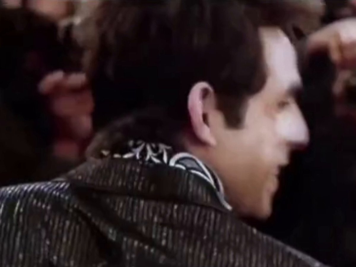 The image shows a man wearing a black and white striped jacket with his back turned towards the camera. The background appears blurry, suggesting that he might be standing in front of a crowd or moving at a fast pace. The caption above him reads "Just opened Pyth feed again and Damn it feels different Everything moves tick by tick in real time This is what powers: Polymarket Perps Kalshi Up/Down markets ... Hyperliquid ... Binance, Coinbase, TradeXYZ Revenue only going up and to the right Oracle war is".