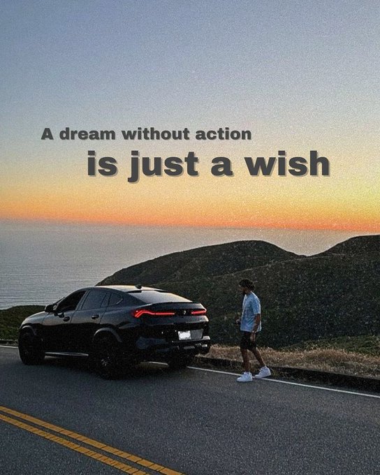 The image features a man walking down a road next to a car parked by the side of the street. The background includes a beautiful sunset over the ocean with a sky filled with clouds, creating a serene atmosphere. The caption for this image reads "A dream without action is just a wish", which seems to be related to the post about building something great today.

The main focus of the image is on the man walking down the road and the car parked by the side of the street. There are no other objects or people in the image, making it a simple yet impactful scene that complements the message of the post.