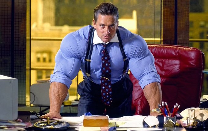 A cinematic still of a muscular man in a blue shirt and suspenders, leaning intensely over an office desk.