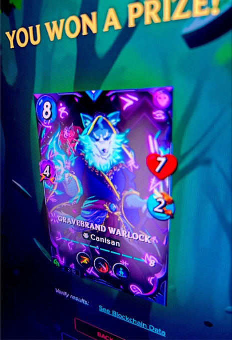 A digital trading card from the Splinterlands platform displays a holographic "YOU WON A PRIZE!" screen featuring a Black Foil Arcane Rare GRAVEBRAND WARLOCK card by user Canisan, with stats showing 8 mana, 4 attack, 7 health, and 2 speed, marked as Mint #2/10. The vibrant neon design and rarity indicators align with the post's celebration of winning the card and welcoming it to the family.