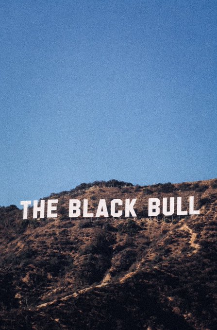 A hillside in the Hollywood Hills displays the iconic "THE BLACK BULL" sign against a clear blue sky. The image, shared with the caption "there will be signs. $ANSEM," visually represents the "signs" referenced in the post, tying the famous landmark to the metaphor about recognizing indicators or signals in the cryptocurrency market.