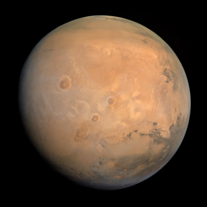A detailed image of Mars shows the planet's reddish-orange surface marked with craters, dust storms, and darker terrain features against the black backdrop of space. The image aligns with the post's claim that simply sharing a visually striking picture of Mars can easily attract engagement from viewers.