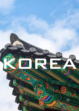 A traditional Korean palace roof with ornate dancheong-style painted eaves in vibrant greens, reds, and blues is overlaid with the bold white text "KOREA" against a blue sky, visually anchoring the caption's discussion of Ripple's RLUSD stablecoin establishing a one-month-interval bridge between Korea and Japan via XRP.